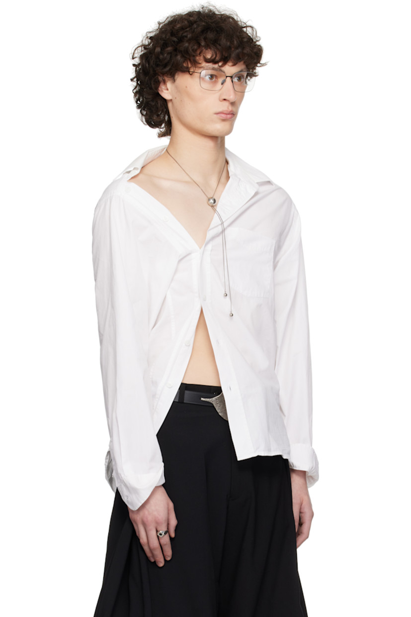 Cotton poplin shirt.

· Asymmetrical construction
· Spread collar
· Offset button closure
· Patch pocket at chest
· Shirttail hem
· Adjustable buttoned barrel cuffs
· Pleats and logo-woven locker loop at back yoke

Each item is constructed using upcycled garments. Please note colorways may vary.