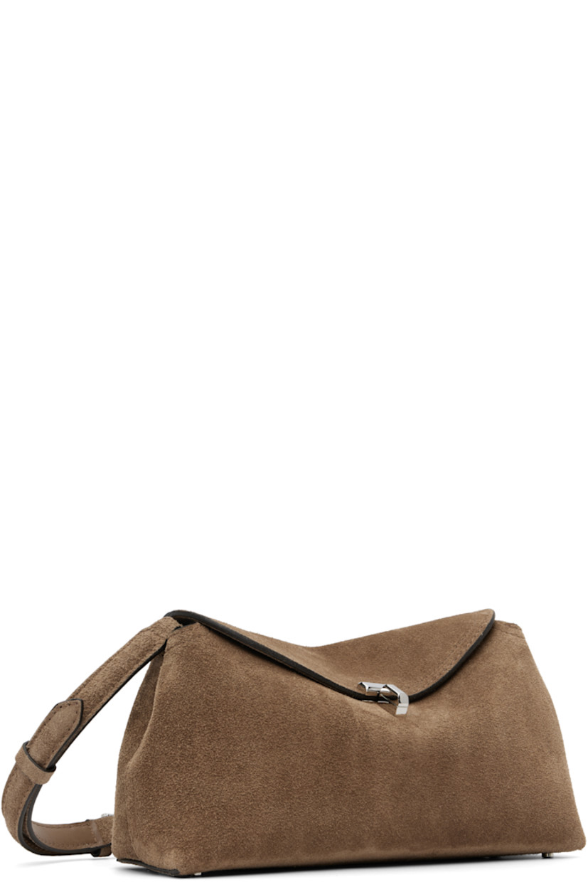 LWG-certified suede clutch.

· Adjustable and detachable shoulder strap
· Bumper studs at base
· Turn-lock flap closure
· Card slot at interior
· Logo-engraved silver-tone hardware
· H5.5" x W10.25" x D3.5"

Supplier color: Tobacco