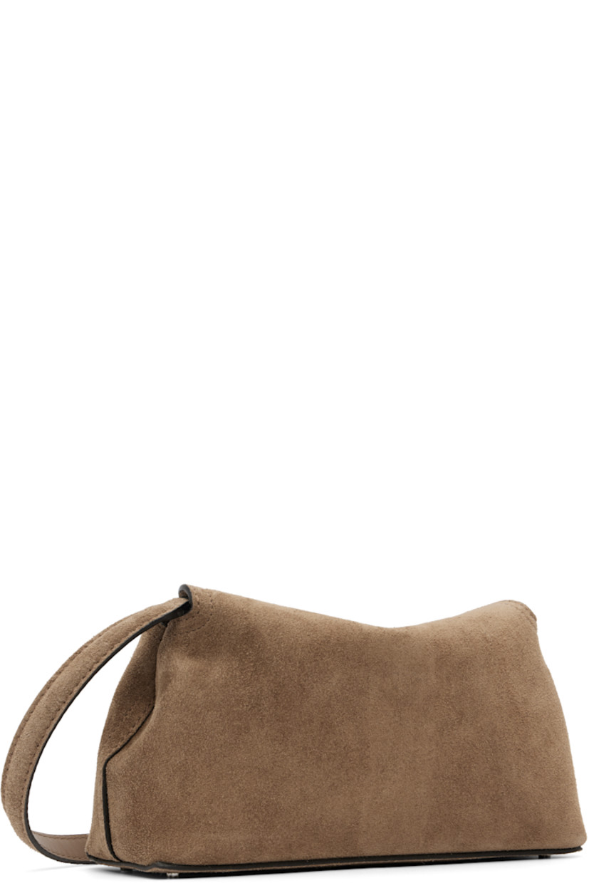 LWG-certified suede clutch.

· Adjustable and detachable shoulder strap
· Bumper studs at base
· Turn-lock flap closure
· Card slot at interior
· Logo-engraved silver-tone hardware
· H5.5" x W10.25" x D3.5"

Supplier color: Tobacco