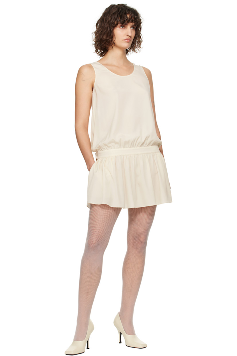 Polyester georgette minidress. 

· Scoop neck
· Gathering at partially elasticized drop waist
· Seam pockets
· Adjustable button strap at back waistband
· Unlined

Supplier color: Cream