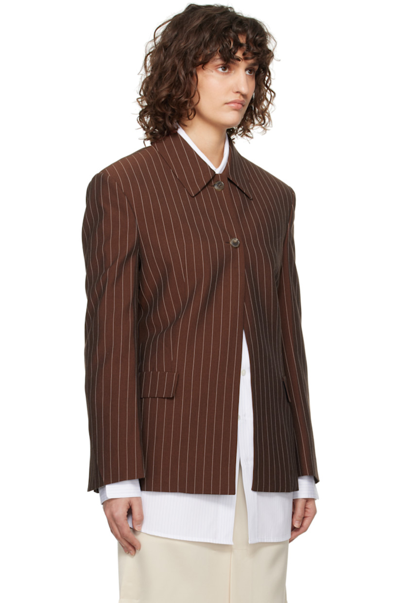 Plain-woven viscose- and lyocell-blend jacket. Pinstripes throughout. 

· Spread collar
· Button closure
· Darts at front
· Flap pockets
· Padded shoulders
· Vented cuffs
· Central vent at back hem
· Partially lined

Supplier color: Red brown