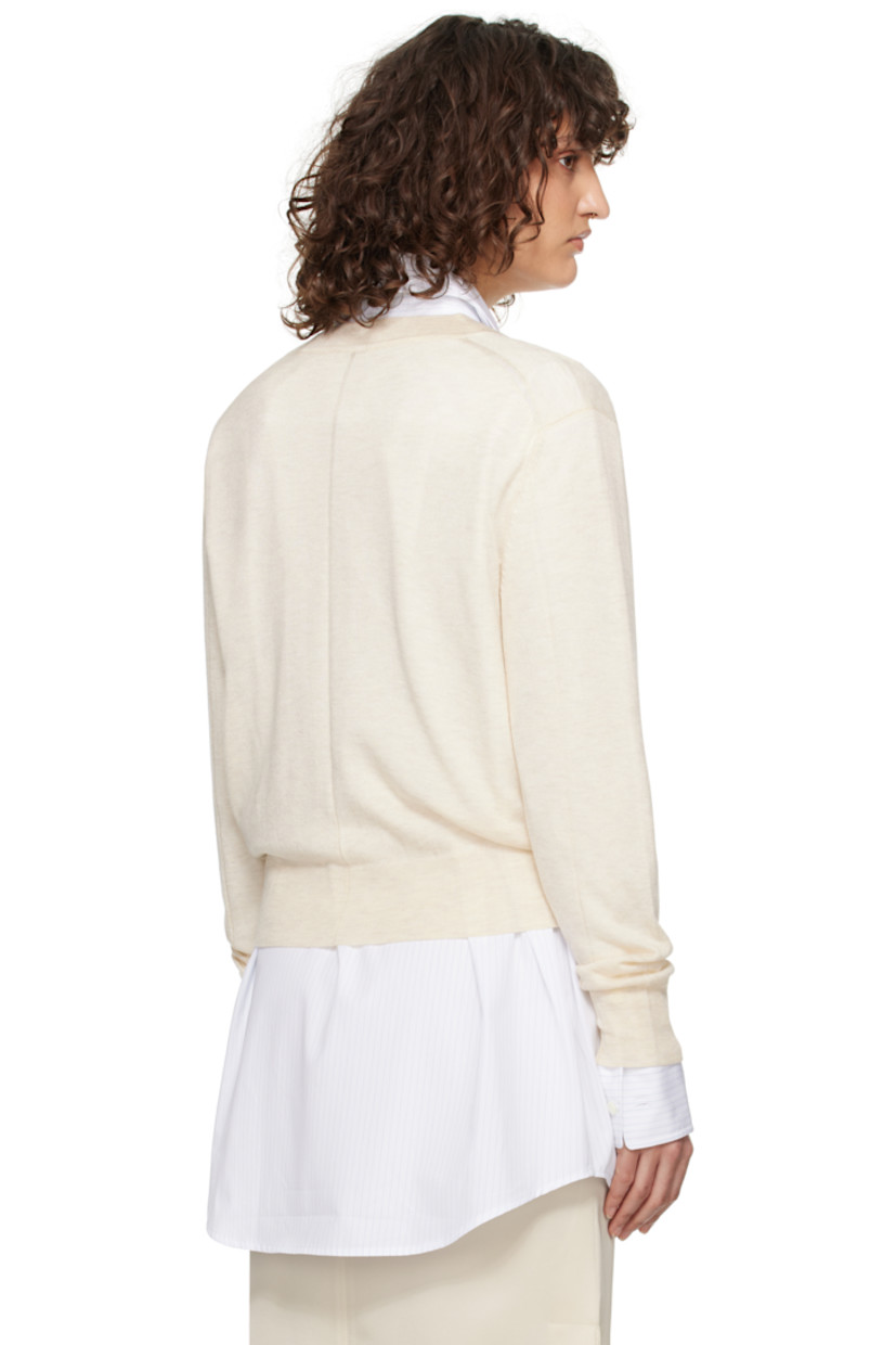Semi-sheer knit acrylic- and tencel-blend sweater. 

· Rib-knit plunging V-neck, hem, and cuffs
· Dropped shoulders
· Central seam at back

Supplier color: Ivory