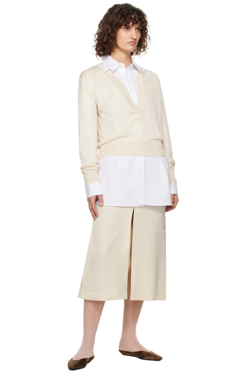 Semi-sheer knit acrylic- and tencel-blend sweater. 

· Rib-knit plunging V-neck, hem, and cuffs
· Dropped shoulders
· Central seam at back

Supplier color: Ivory
