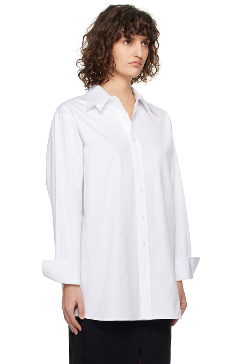 Cotton poplin shirt. Pinstripes throughout. 

· Layered spread collar
· Button closure
· Shirttail hem
· Two-button barrel cuffs
· Twin pleats at back yoke

Supplier color: Light blue