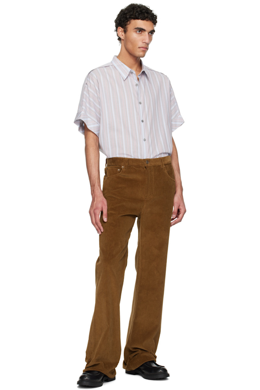 Plain-woven cotton overshirt. Stripes throughout. 

· Spread collar
· Button closure 
· Modified epaulets
· Dolman sleeves
· Rolled cuffs
· Twin pleats at back yoke

Supplier color: Light grey