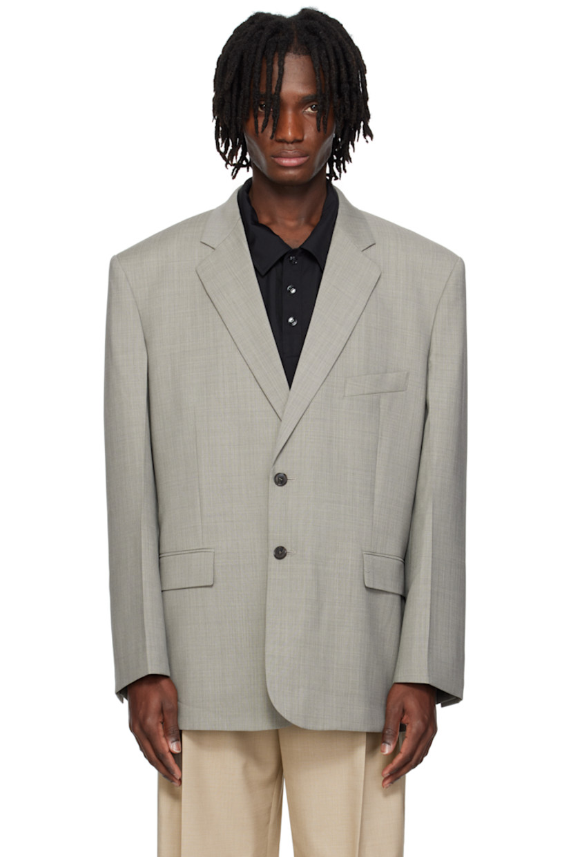 Oversized plain-woven polyester-and wool-blend blazer.

· Notched lapel
· Button closure
· Welt pocket and flap pockets
· Darts at front 
· Padded shoulders
· Surgeon's cuffs
· Welt pocket at interior
· Full satin lining
· Horn hardware

Supplier color: Charcoal grey