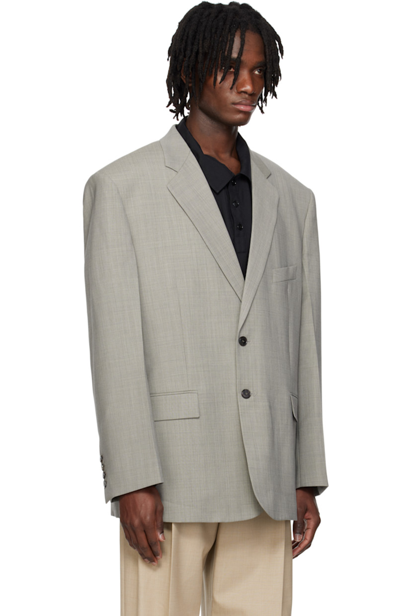 Oversized plain-woven polyester-and wool-blend blazer.

· Notched lapel
· Button closure
· Welt pocket and flap pockets
· Darts at front 
· Padded shoulders
· Surgeon's cuffs
· Welt pocket at interior
· Full satin lining
· Horn hardware

Supplier color: Charcoal grey