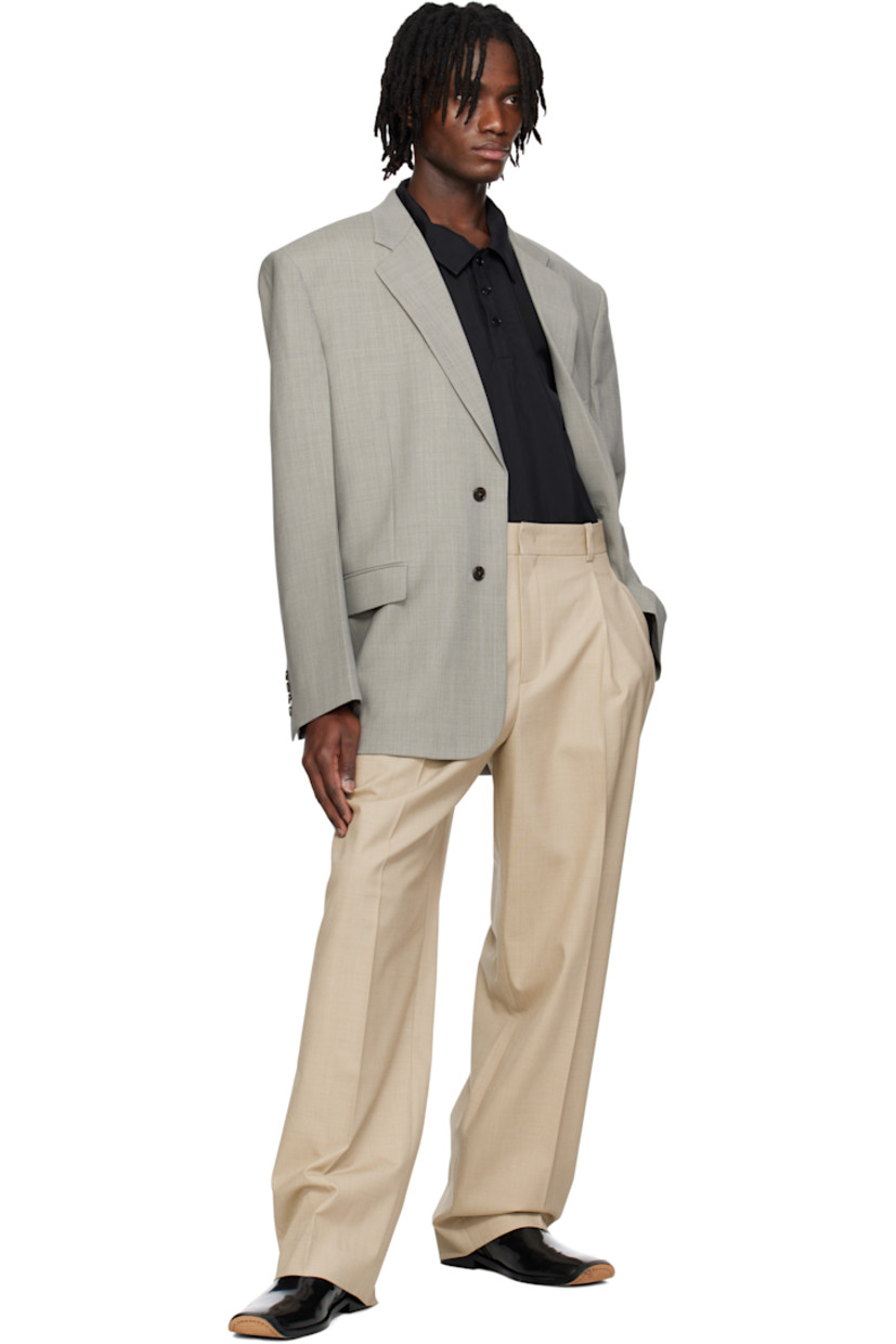 Oversized plain-woven polyester-and wool-blend blazer.

· Notched lapel
· Button closure
· Welt pocket and flap pockets
· Darts at front 
· Padded shoulders
· Surgeon's cuffs
· Welt pocket at interior
· Full satin lining
· Horn hardware

Supplier color: Charcoal grey