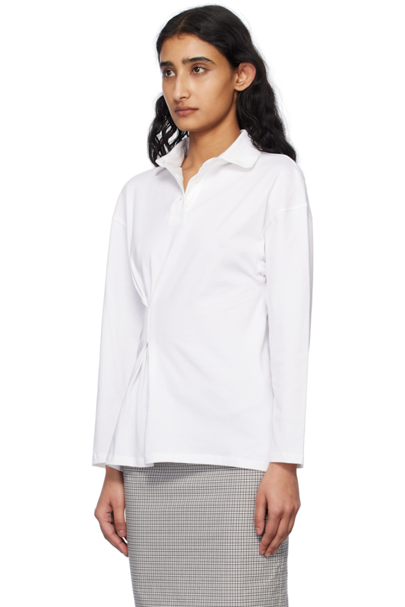 Stretch cotton piqué polo. 

· Rib-knit spread collar
· Three-button placket
· Offset pleat at front 
· Dropped shoulders

Supplier color: White