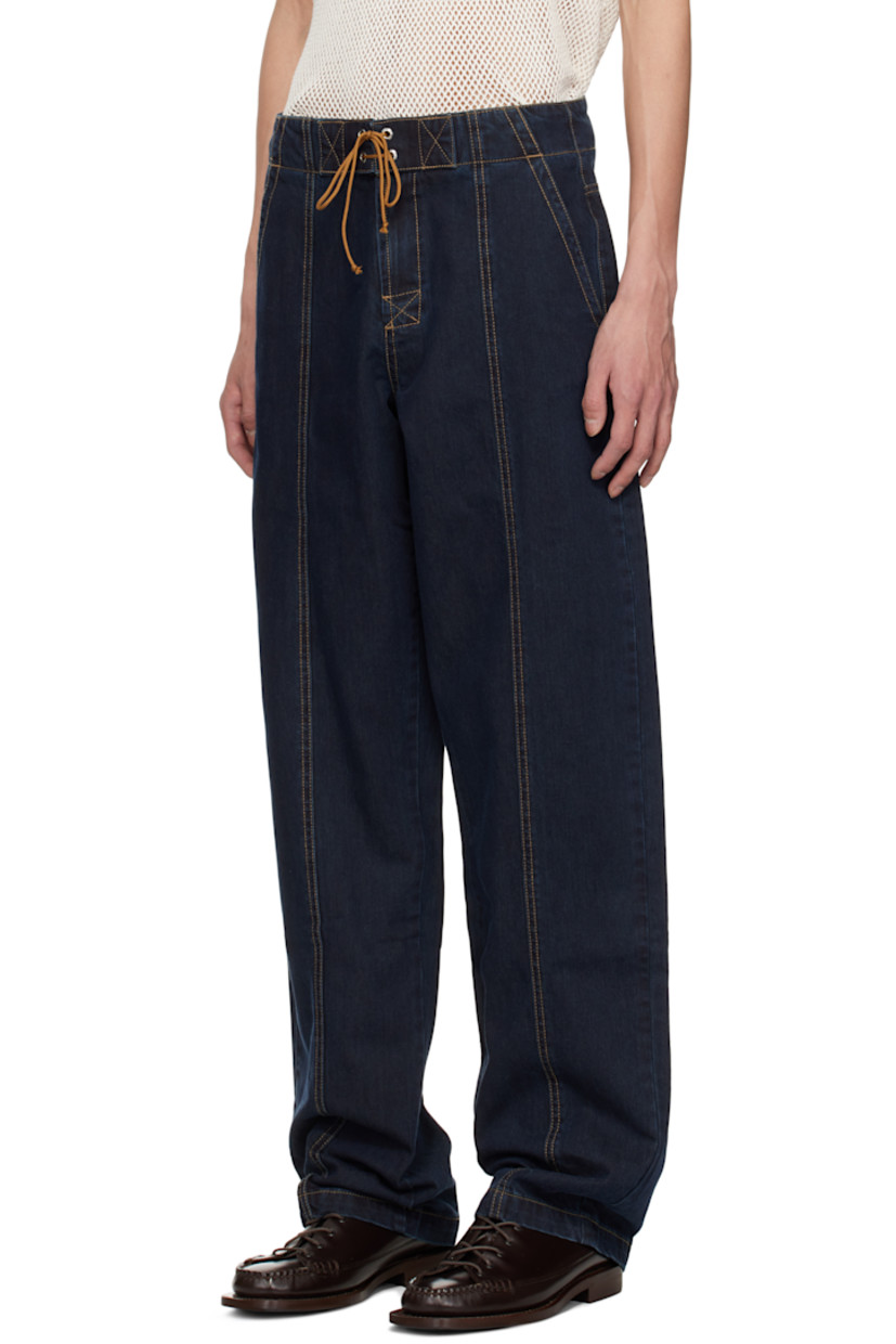 Non-stretch denim jeans. 

· Lace-up closure at waistband
· Four-pocket styling
· Zip-fly
· Central seams at front and back 
· Contrast stitching in tan

Supplier color: Navy