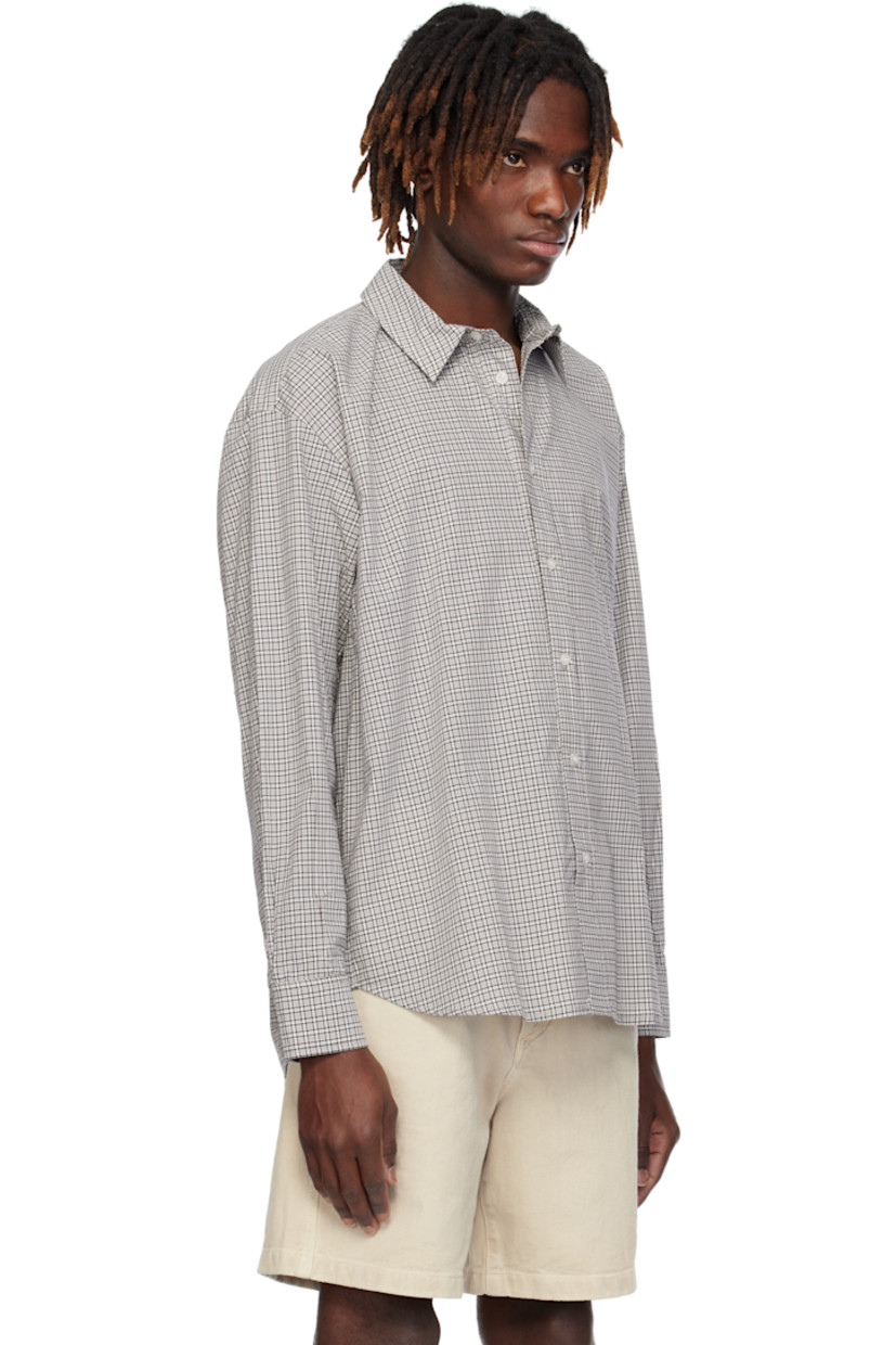 Cotton poplin shirt. Check pattern throughout. 

· Spread collar
· Button closure
· Shirttail hem
· Dropped shoulders
· Single-button barrel cuffs

Supplier color: Grey