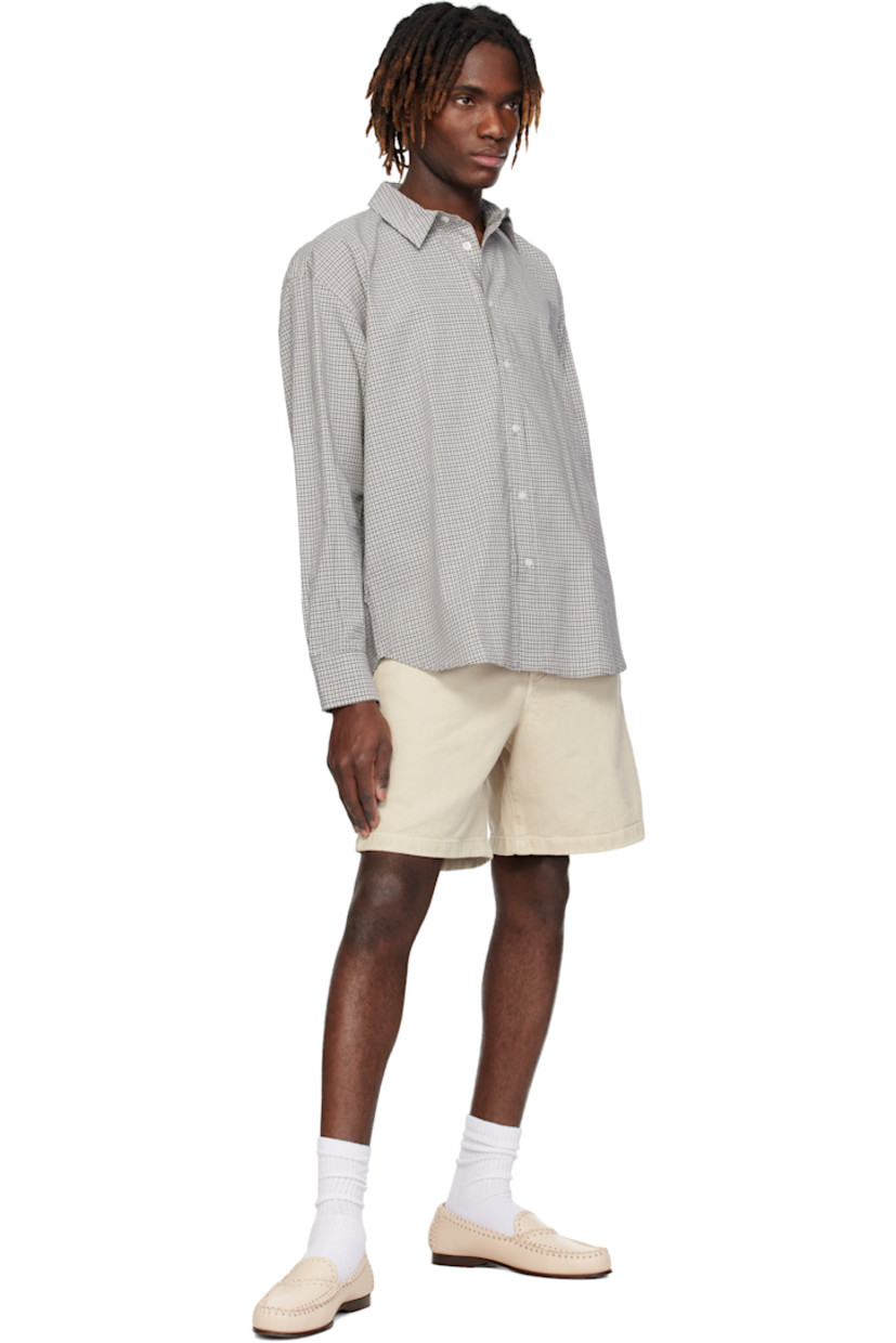 Cotton poplin shirt. Check pattern throughout. 

· Spread collar
· Button closure
· Shirttail hem
· Dropped shoulders
· Single-button barrel cuffs

Supplier color: Grey