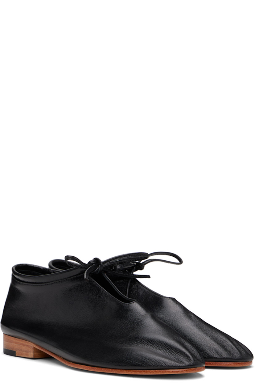 Handcrafted grained kidskin loafers in black.

· Self-tie closure
· Grained kidskin and suede lining
· Stacked leather heel with rubber injection
· Leather sole

Supplier color: Black