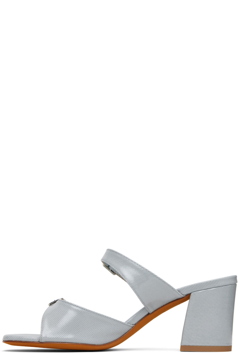 Coated denim heeled sandals.

· Open square toe
· Pin-buckle straps at vamp
· Logo embossed at padded footbed
· Covered block heel with rubber injection
· Nubuck sole
· Heel: H2.75"

Supplier color: Ouran fabric