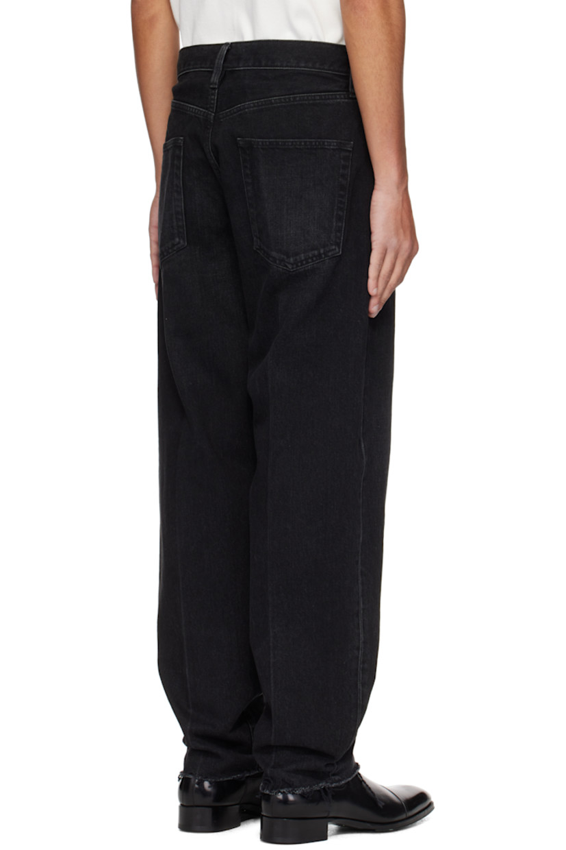 Tapered non-stretch denim jeans. Fading and whiskering throughout.

· Belt loops
· Five-pocket styling
· Button fly
· Rubberized logo patch at front
· Creased legs 
· Frayed edge at cuffs 
· Logo-engraved bronze-tone hardware

Supplier color: Black