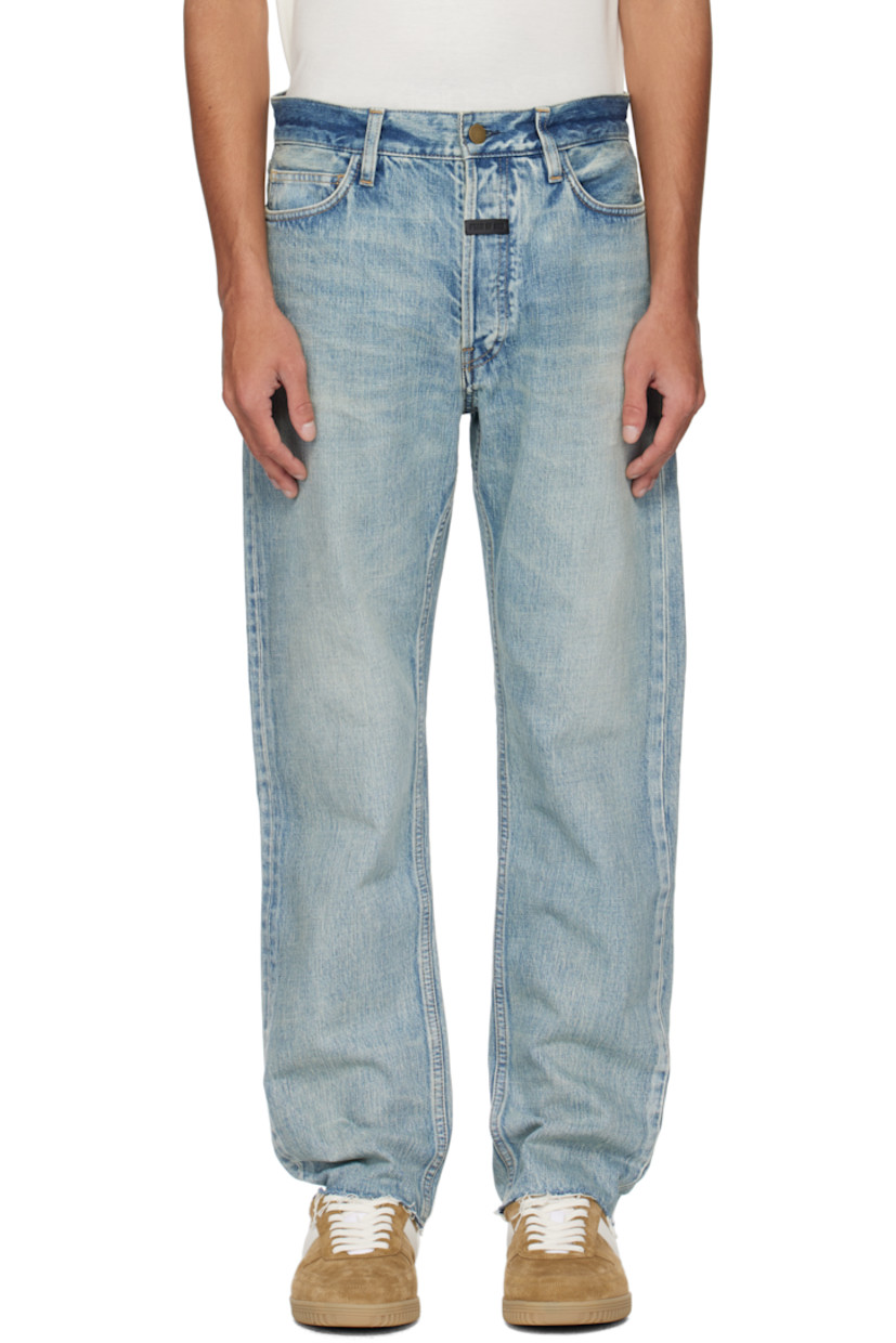 Straight-leg non-stretch denim jeans. Fading and whiskering throughout. 

· Belt loops
· Five-pocket styling
· Button fly
· Rubberized logo patch at front
· Frayed edge at cuffs 
· Logo-engraved bronze-tone hardware
· Contrast stitching in tan 

Supplier color: Medium indigo