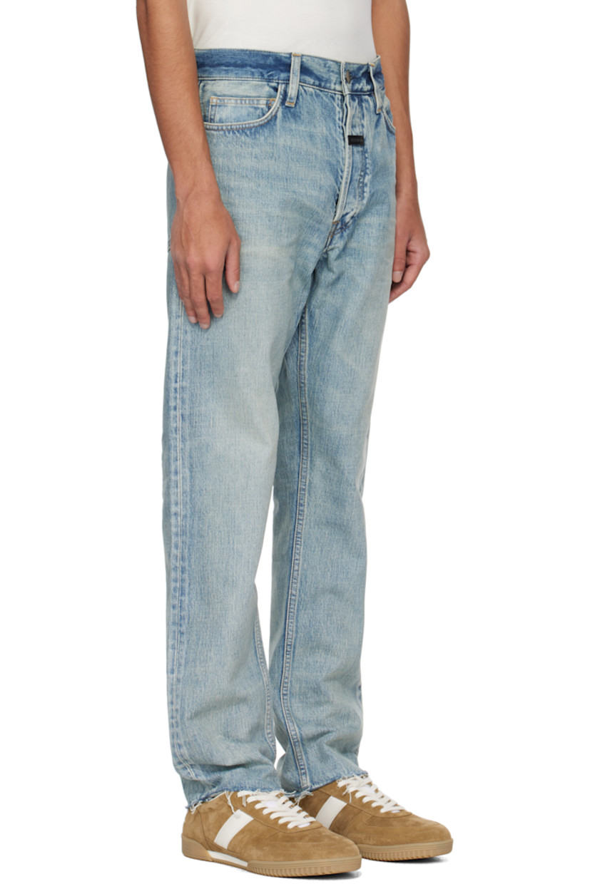 Straight-leg non-stretch denim jeans. Fading and whiskering throughout. 

· Belt loops
· Five-pocket styling
· Button fly
· Rubberized logo patch at front
· Frayed edge at cuffs 
· Logo-engraved bronze-tone hardware
· Contrast stitching in tan 

Supplier color: Medium indigo