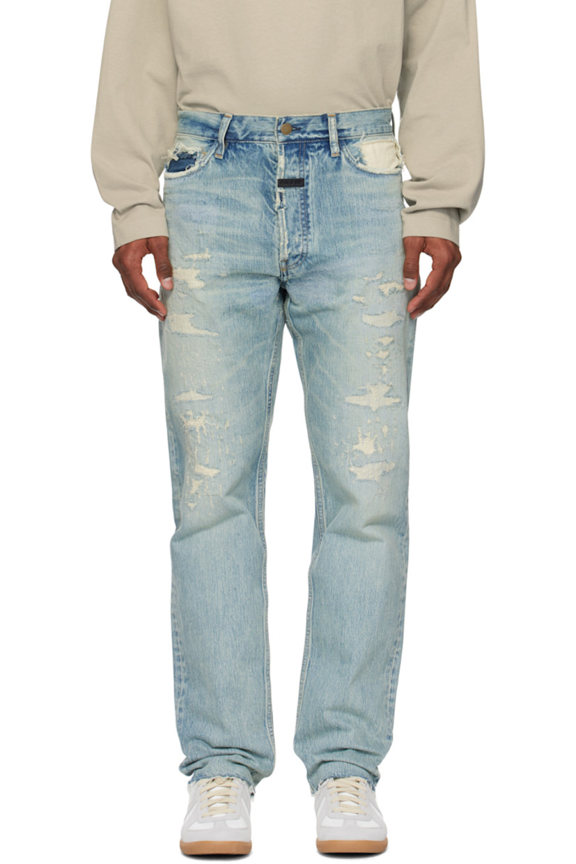 Straight-leg non-stretch denim jeans. Fading, hand-distressing, and topstitching throughout.

· Belt loops
· Five-pocket styling
· Logo patch at button fly
· Frayed edge at cuffs
· Contrast stitching in tan

Supplier color: Repaired medium indigo