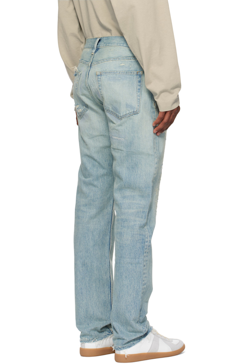 Straight-leg non-stretch denim jeans. Fading, hand-distressing, and topstitching throughout.

· Belt loops
· Five-pocket styling
· Logo patch at button fly
· Frayed edge at cuffs
· Contrast stitching in tan

Supplier color: Repaired medium indigo
