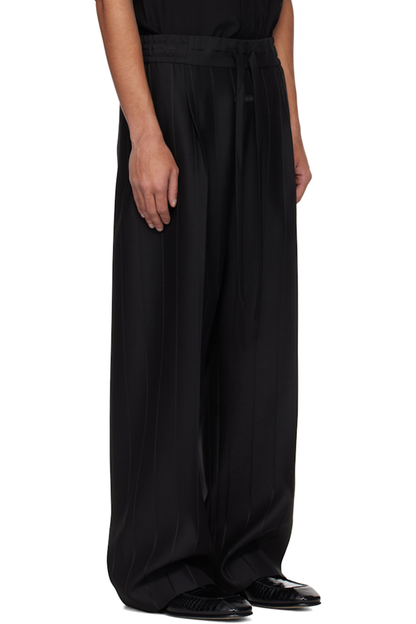 Heavyweight viscose- and virgin wool-blend twill trousers. Stripes throughout. 

· Wide-leg
· Drawstring at elasticized waistband 
· Two-pocket styling 
· Pleats and rubberized logo patch at front 
· Creased legs 
· Full satin lining 

Supplier color: Black