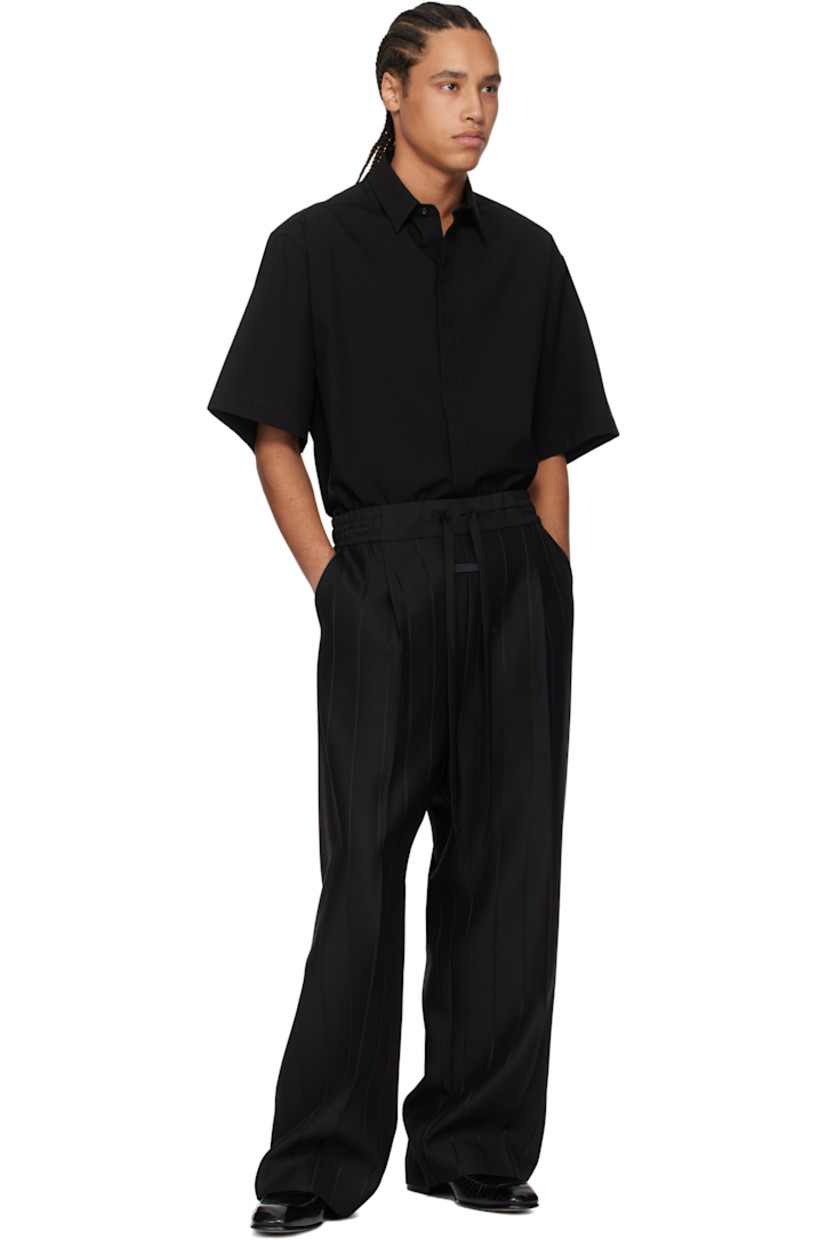 Heavyweight viscose- and virgin wool-blend twill trousers. Stripes throughout. 

· Wide-leg
· Drawstring at elasticized waistband 
· Two-pocket styling 
· Pleats and rubberized logo patch at front 
· Creased legs 
· Full satin lining 

Supplier color: Black