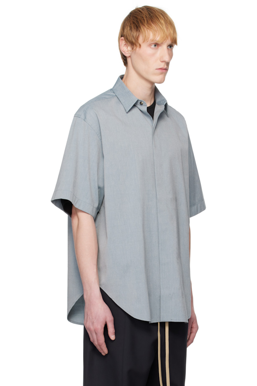 Stretch cotton- and virgin wool-blend oxford cloth shirt. 

· Spread collar
· Concealed button closure 
· Shirttail hem
· Rubberized logo patch at back collar
· Twin pleats at back yoke 
· Horn hardware

Supplier color: Melange slate