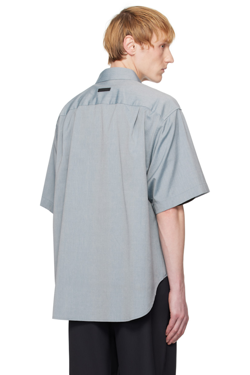Stretch cotton- and virgin wool-blend oxford cloth shirt. 

· Spread collar
· Concealed button closure 
· Shirttail hem
· Rubberized logo patch at back collar
· Twin pleats at back yoke 
· Horn hardware

Supplier color: Melange slate