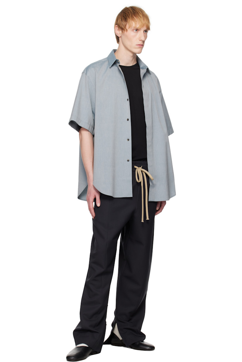 Stretch cotton- and virgin wool-blend oxford cloth shirt. 

· Spread collar
· Concealed button closure 
· Shirttail hem
· Rubberized logo patch at back collar
· Twin pleats at back yoke 
· Horn hardware

Supplier color: Melange slate