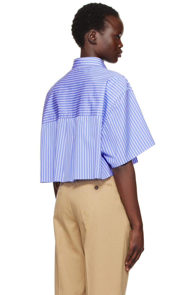 Oversized cotton poplin shirt. Stripes throughout.

· Spread collar
· Button closure
· Logo embroidered at front
· Cropped hem
· Raw edge at hem and cuffs
· Dropped shoulders
· Box pleat at back yoke

Supplier color: Blue stripe