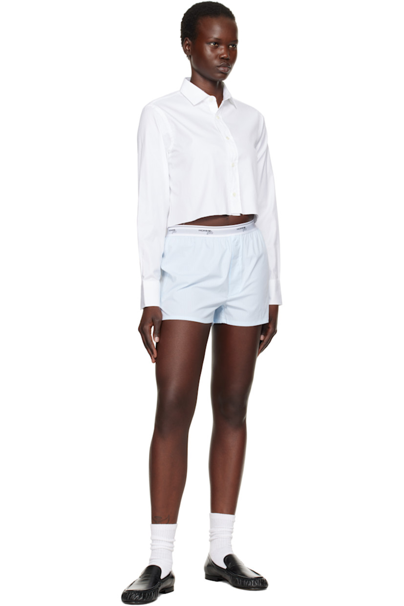Cotton twill shirt.

· Spread collar
· Button closure
· Logo embroidered at front
· Raw edge at cropped hem
· Pleat at adjustable single-button barrel cuffs
· Box pleat at back yoke

Supplier color: White