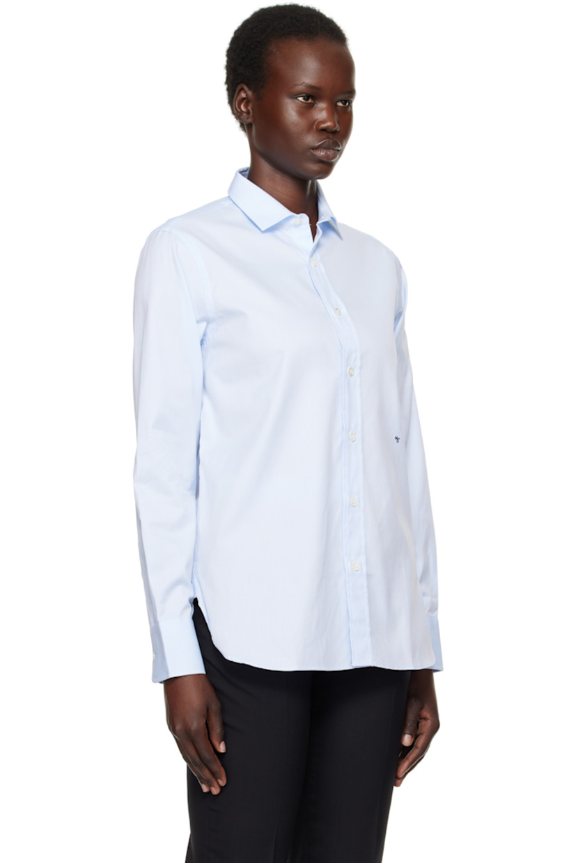 Cotton twill shirt.

· Spread collar
· Button closure
· Logo embroidered at front
· Shirttail hem
· Pleat at adjustable single-button barrel cuffs
· Box pleat at back yoke

Supplier color: Chambray blue