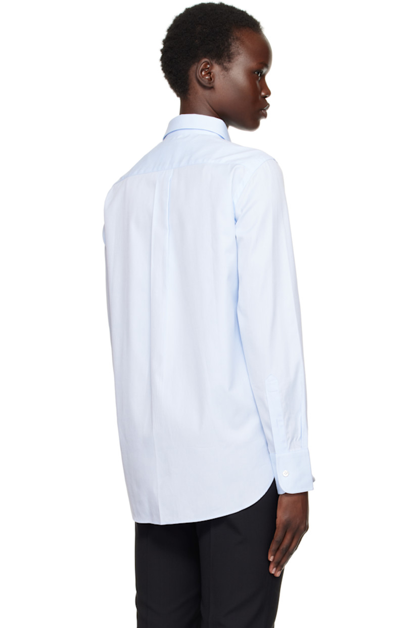 Cotton twill shirt.

· Spread collar
· Button closure
· Logo embroidered at front
· Shirttail hem
· Pleat at adjustable single-button barrel cuffs
· Box pleat at back yoke

Supplier color: Chambray blue