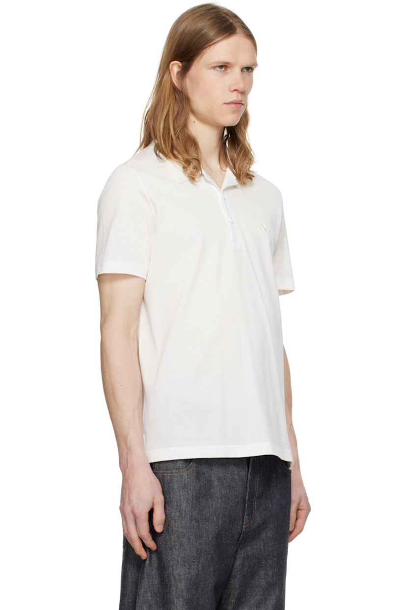 Cotton piqué polo.

· Rib-knit spread collar
· Three-button placket
· Embroidered logo patch at chest
· Tennis-tail hem
· Extended loop with embroidered logo at back collar

Supplier color: White