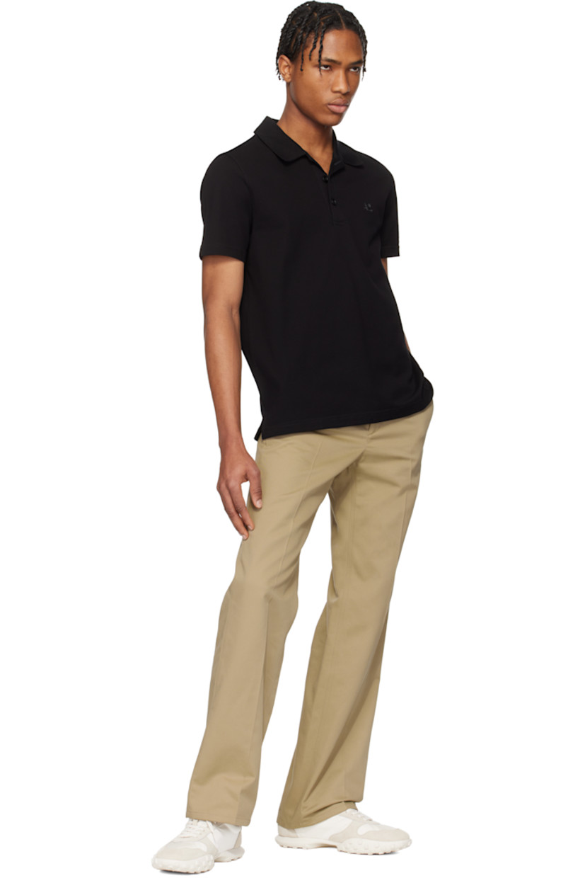 Cotton piqué polo. 

· Rib-knit spread collar
· Three-button placket
· Logo embroidered at chest
· Tennis-tail hem
· Extended loop with embroidered logo at back collar

Supplier color: Black