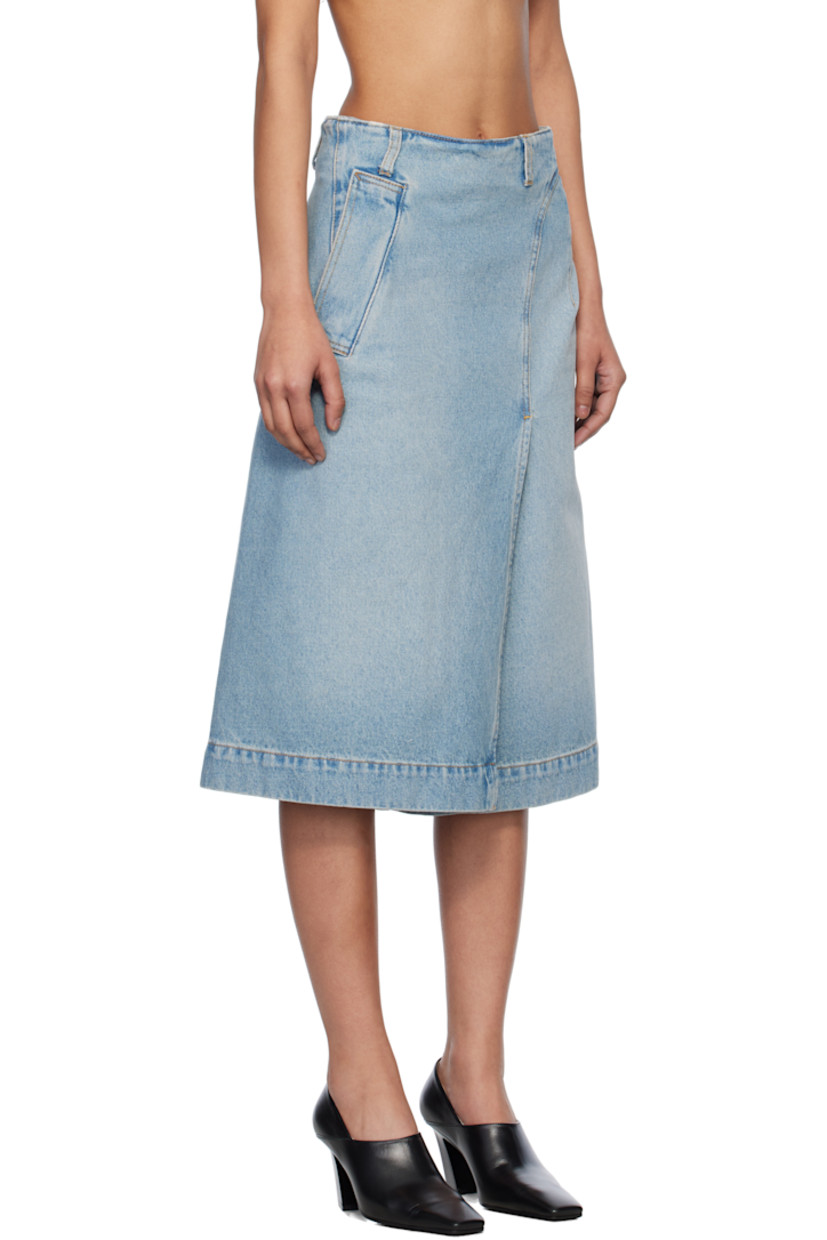 Non-stretch denim midi skirt. Fading throughout. 

· Mock-wrap construction
· Belt loops
· Three-pocket styling
· Dart at front
· Offset vent at front and back
· Zip closure with button tab at side
· Leather logo patch at back waistband
· Contrast stitching in tan and red

Supplier color: Pale blue wash