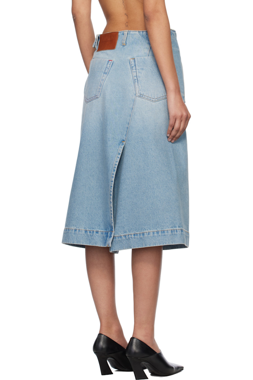 Non-stretch denim midi skirt. Fading throughout. 

· Mock-wrap construction
· Belt loops
· Three-pocket styling
· Dart at front
· Offset vent at front and back
· Zip closure with button tab at side
· Leather logo patch at back waistband
· Contrast stitching in tan and red

Supplier color: Pale blue wash