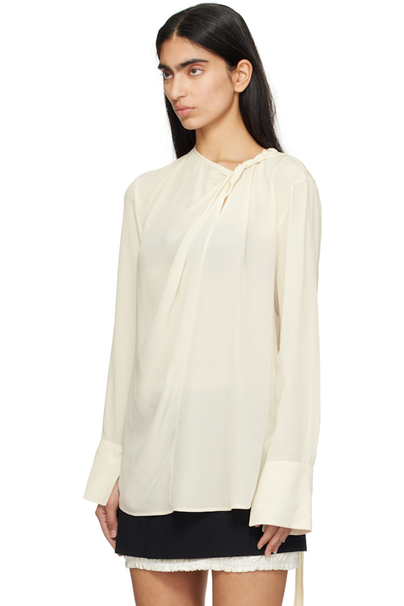 Silk crepe de chine blouse. Gathering throughout.

· Twisting and zip fastening at crewneck
· Vented cuffs
· Self-tie strap at back collar

Supplier color: Ivory