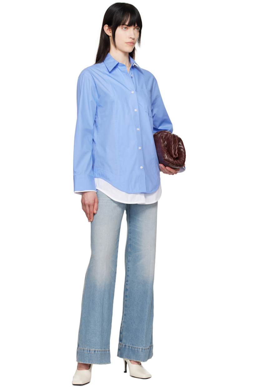 Organic cotton poplin shirt.

· Layered construction
· Spread collar
· Button closure
· Patch pocket at chest
· Logo embroidered at front
· Shirttail hem
· Single-button barrel cuffs

Supplier color: Oxford blue