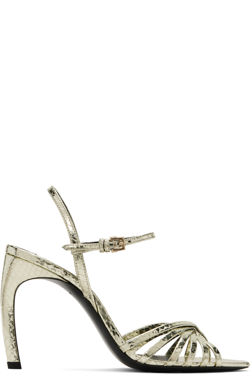 Snake-embossed patent kidskin heeled sandals in metallic gold tone.

· Open pointed toe
· Criss-crossing straps at vamp
· Adjustable pin-buckle ankle strap
· Logo patch at leather footbed
· Covered stiletto heel with rubber injection
· Polished leather sole
· Heel: H3.75"

Supplier color: Printed phyton