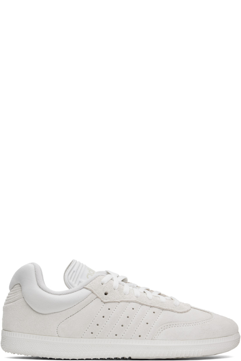 Low-top suede sneakers in off-white.

· Lace-up closure
· Embossed detailing and logo at tongue
· Padded collar
· Perforations at sides
· Quilted signature stripes at sides
· Terrycloth lining
· Treaded rubber sole

Part of the Dingyun Zhang x adidas Originals collaboration.

Supplier color: White vapour/White vapour/Grey one