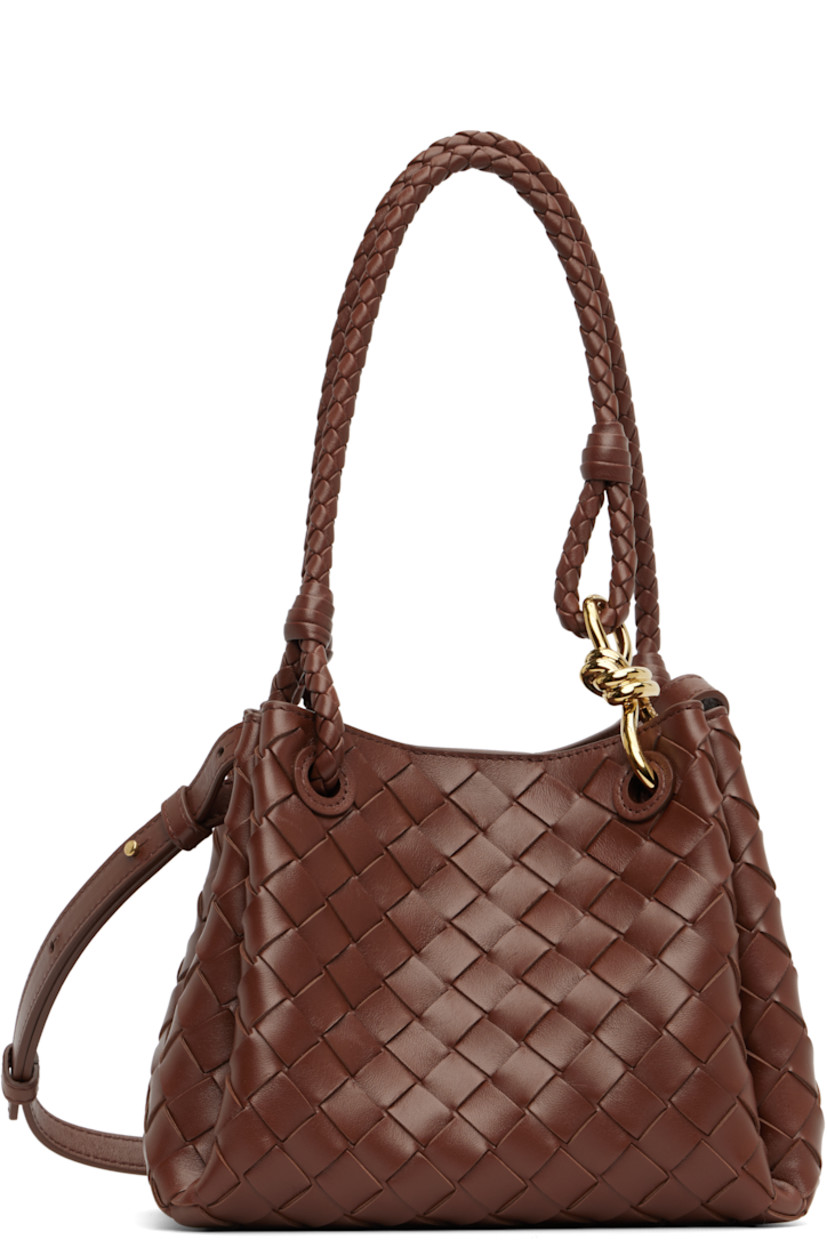Intrecciato-woven buffed lambskin shoulder bag.

· Fixed shoulder straps with knot hardware 
· Adjustable and detachable crossbody strap
· Magnetic closure
· H7.5" x W9" x D6"

Supplier color: Sapele