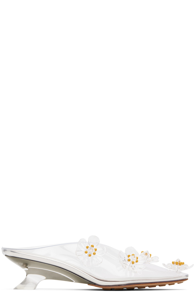 Transparent vinyl slip-on heels.

· Pointed toe
· Floral appliqu�és at vamp
· Eyelets at inner side
· Kitten heel
· Leather sole with rubber injections

Supplier color: Glass