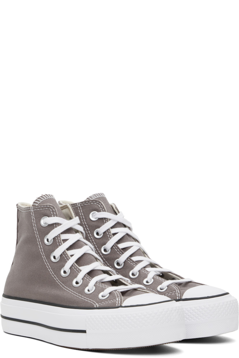 High-top canvas sneakers in taupe.

· Rubber cap toe
· Lace-up closure
· Logo patch and eyelets at inner side
· Cushioned OrthoLite® footbed
· Mesh lining
· Rubberized logo patch at heel
· Treaded rubber platform sole
· Contrast stitching in white
· Platform: H1.25"

Supplier color: Pure pumice/White/Black