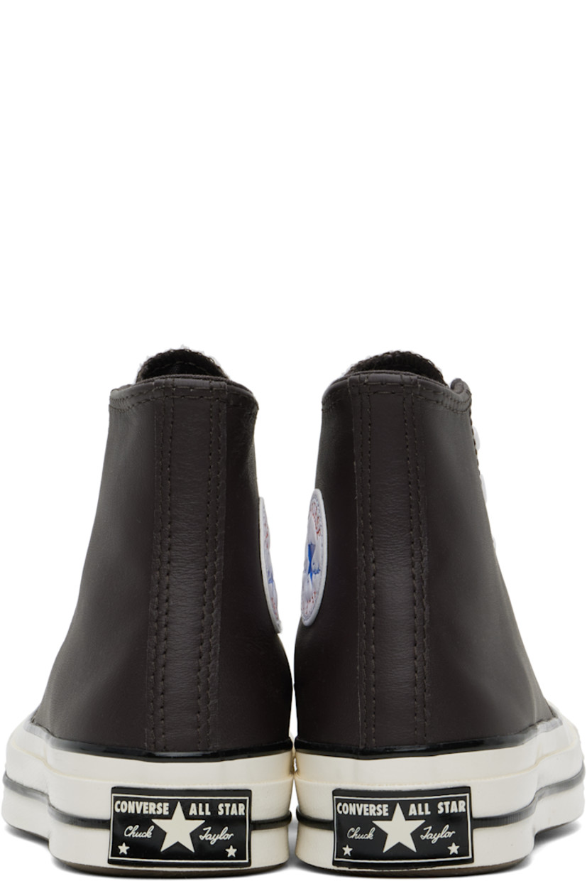 High-top grained leather sneakers in brown.

· Rubber cap toe
· Lace-up closure
· Logo patch and eyelets at inner side
· Cushioned OrthoLite® footbed
· Canvas lining
· Rubberized logo patch at heel
· Treaded rubber sole

Supplier color: Coffee nut/Blue/White