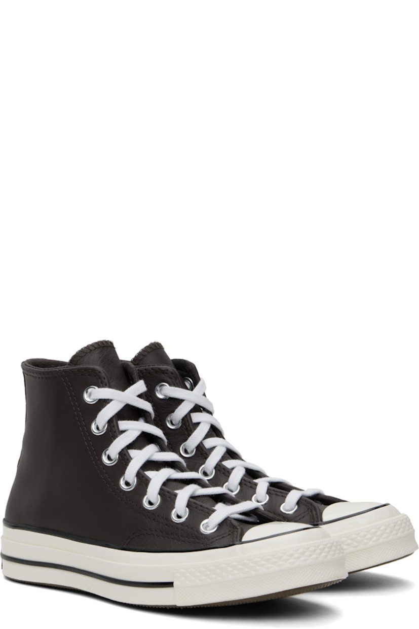 High-top grained leather sneakers in brown.

· Rubber cap toe
· Lace-up closure
· Logo patch and eyelets at inner side
· Cushioned OrthoLite® footbed
· Canvas lining
· Rubberized logo patch at heel
· Treaded rubber sole

Supplier color: Coffee nut/Blue/White
