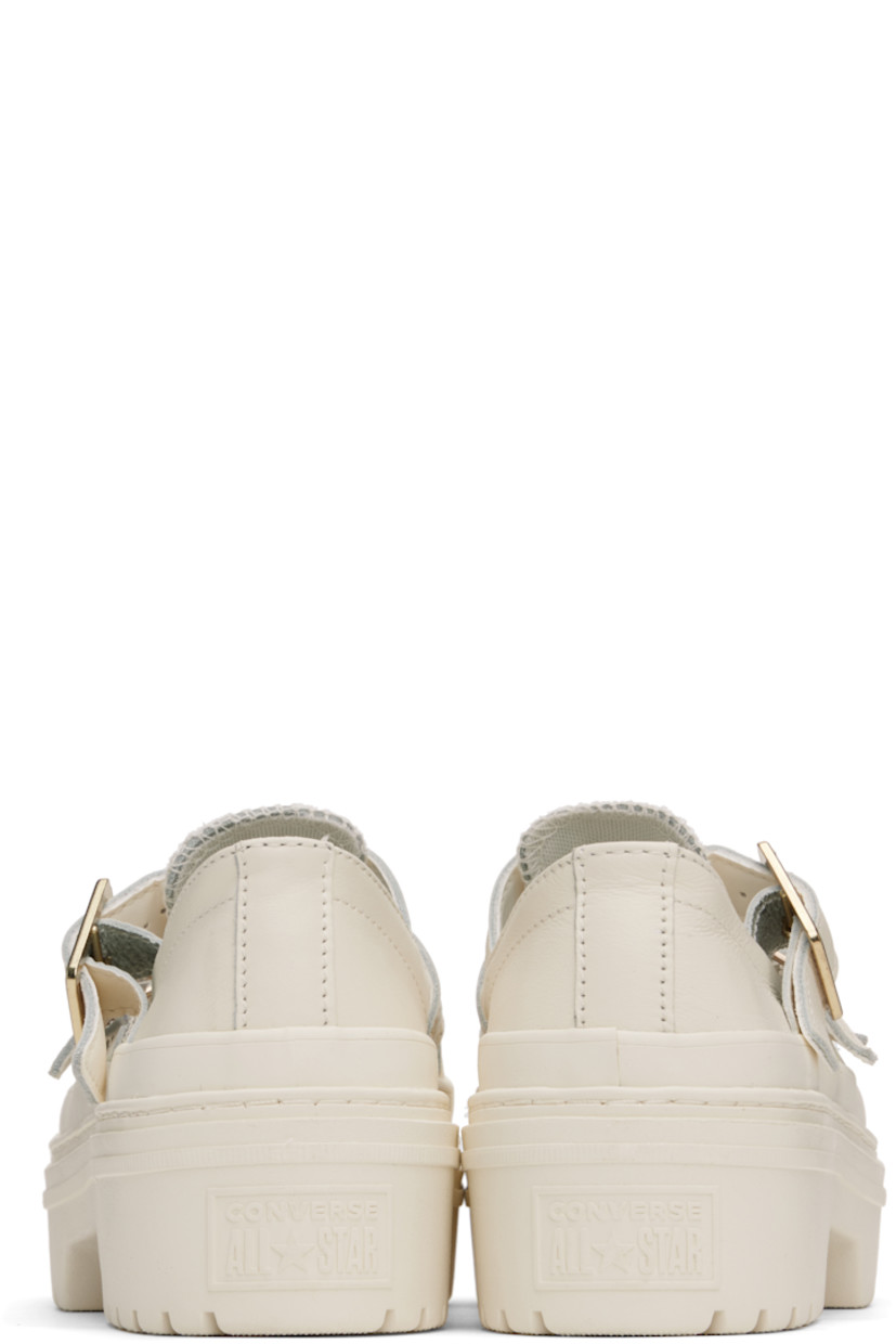 Low-top grained leather Mary Jane-style sneakers in off-white.

· Rubber cap toe
· Pin-buckle straps at vamp
· Cushioned OrthoLite® insole
· Rubberized logo patch at heel
· Treaded rubber sole 
· Platform: H2"

Supplier color: Egret/Egret/Gold