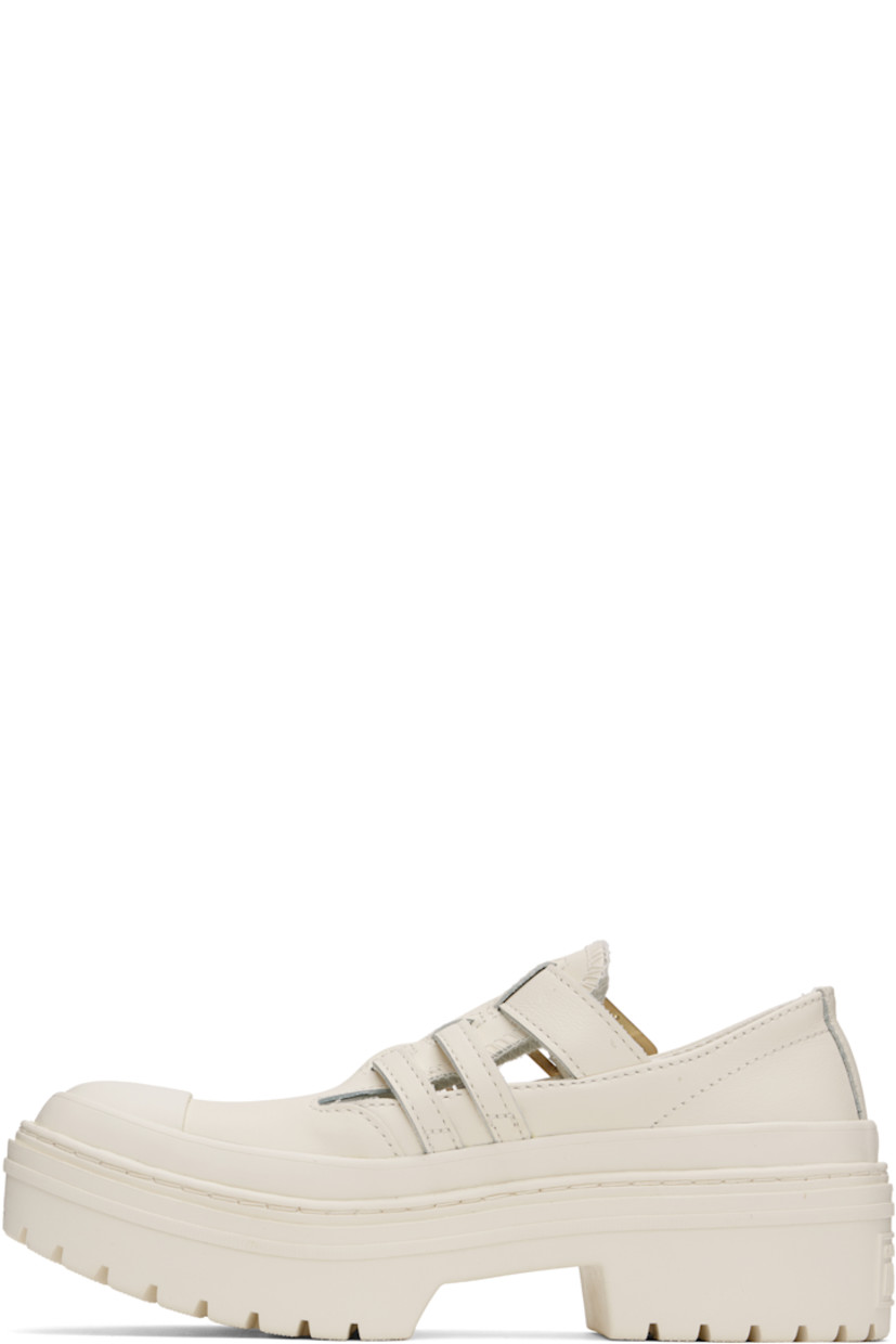 Low-top grained leather Mary Jane-style sneakers in off-white.

· Rubber cap toe
· Pin-buckle straps at vamp
· Cushioned OrthoLite® insole
· Rubberized logo patch at heel
· Treaded rubber sole 
· Platform: H2"

Supplier color: Egret/Egret/Gold