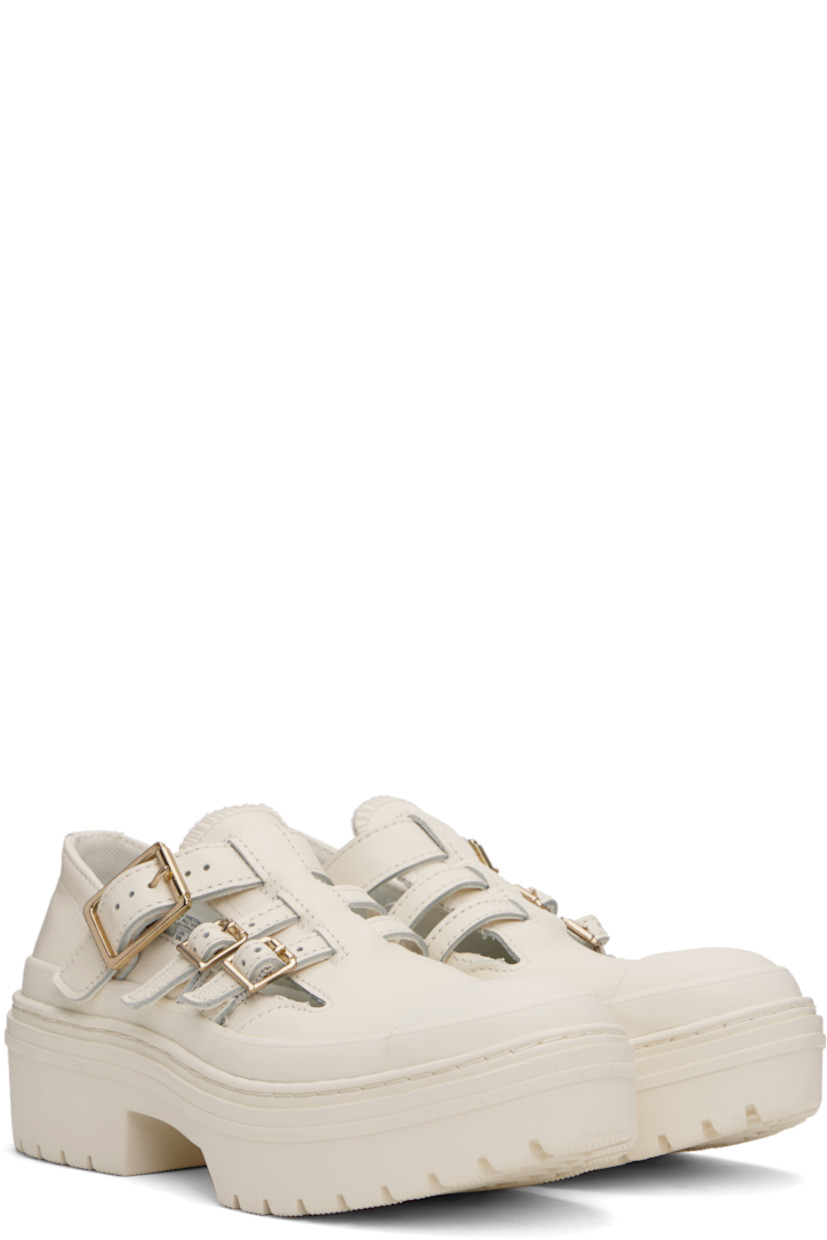 Low-top grained leather Mary Jane-style sneakers in off-white.

· Rubber cap toe
· Pin-buckle straps at vamp
· Cushioned OrthoLite® insole
· Rubberized logo patch at heel
· Treaded rubber sole 
· Platform: H2"

Supplier color: Egret/Egret/Gold