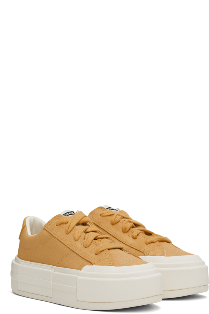 Low-top canvas and suede sneakers in tan.

· Lace-up closure
· Logo printed at tongue and heel
· Padded collar
· Cushioned OrthoLite® insole
· Treaded rubber platform sole
· Platform: H2"

Supplier color: Sandy shore/Egret/Sandy shore