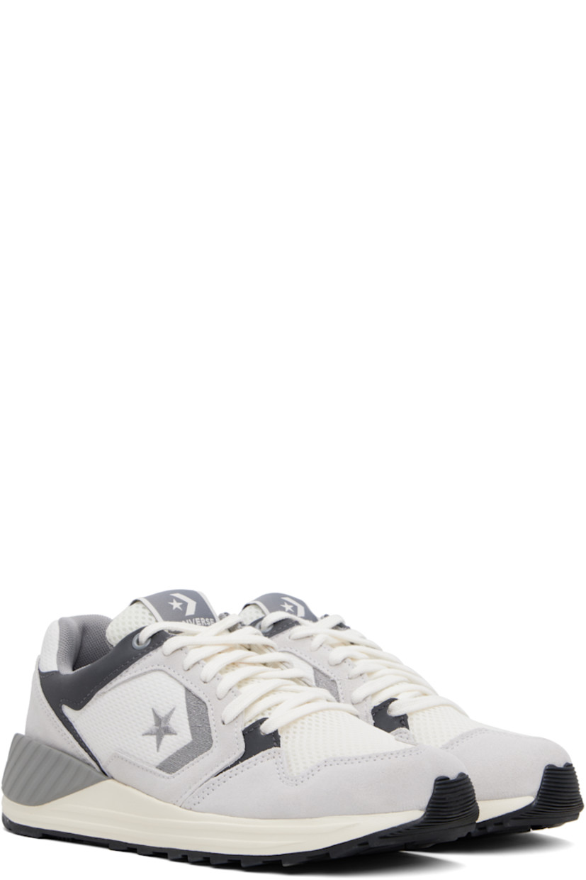 Low-top suede and mesh sneakers in gray.

· Lace-up closure
· Logo flag at padded tongue
· Padded collar
· Logo embroidered at sides 
· Logo embossed at heel counter
· Cushioned CX foam footbed
· Mesh lining
· Treaded rubber sole

Supplier color: Barely grey/Vintage white